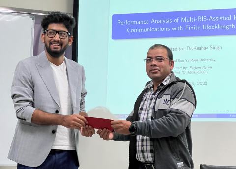 A lab member receives a red envelope in front of a presentation slide on multi-RIS-assisted full-duplex communications.