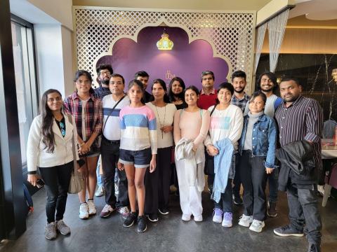 Group photo of lab members in a decorated restaurant dining room.