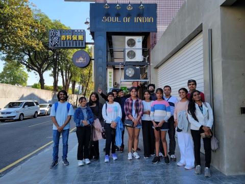 Group photo of lab members outside the Soul of India restaurant.