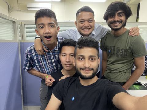 Selfie of four lab members in the lab.
